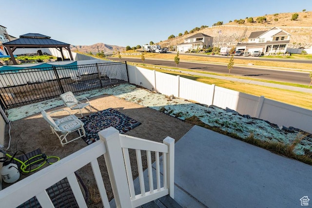 7390 N Pawnee Rd, Eagle Mountain, UT 84005 - fenced yard with a mountain view, a gazebo, and a residential view