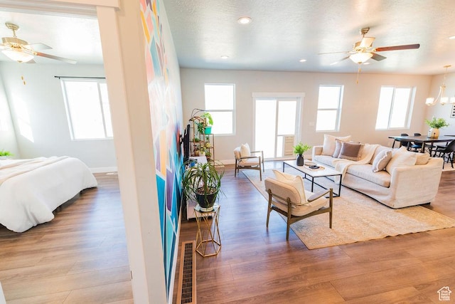 7390 N Pawnee Rd, Eagle Mountain, UT 84005 - living room with ceiling fan, wood finished floors, and recessed lighting