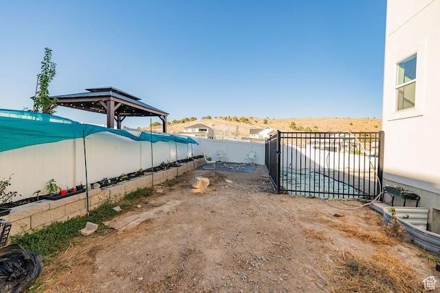 7390 N Pawnee Rd, Eagle Mountain, UT 84005 - fenced backyard with a gazebo