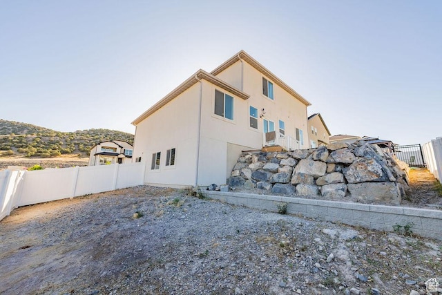7390 N Pawnee Rd, Eagle Mountain, UT 84005 - back of property with a fenced backyard and stucco siding
