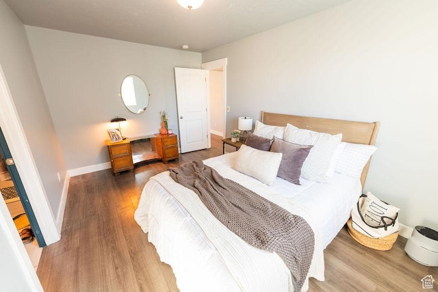 7390 N Pawnee Rd, Eagle Mountain, UT 84005 - bedroom featuring wood finished floors and baseboards