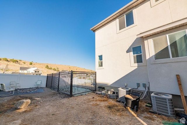 7390 N Pawnee Rd, Eagle Mountain, UT 84005 - view of side of home featuring a central AC unit and stucco siding