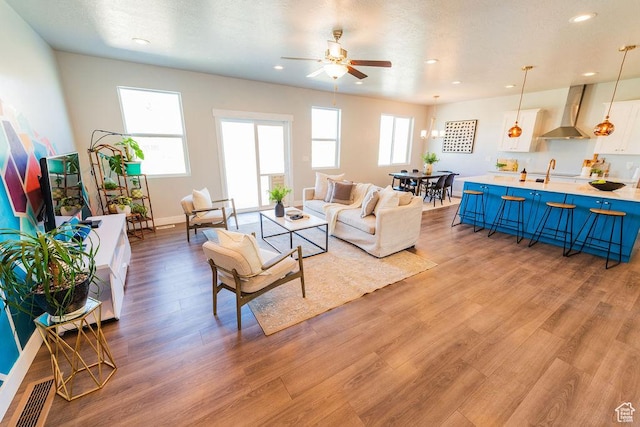 7390 N Pawnee Rd, Eagle Mountain, UT 84005 - living room featuring ceiling fan, light wood finished floors, and recessed lighting