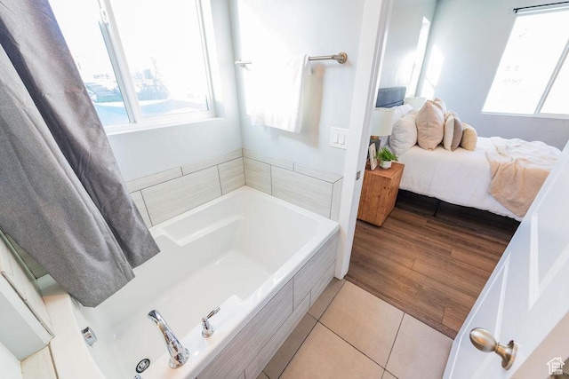 7390 N Pawnee Rd, Eagle Mountain, UT 84005 - ensuite bathroom with a garden tub and tile patterned flooring