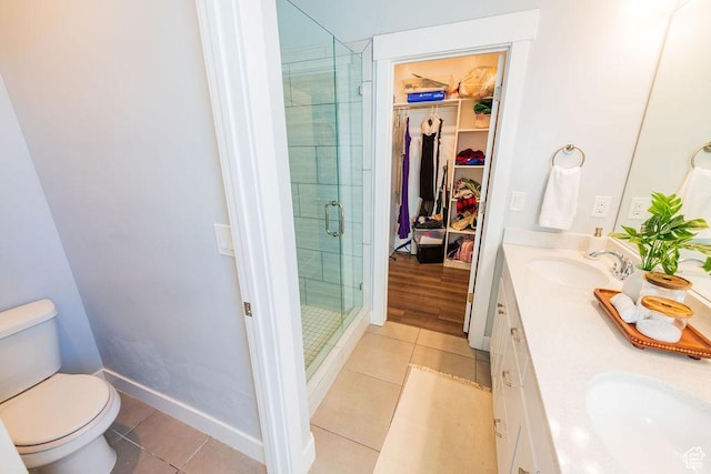 7390 N Pawnee Rd, Eagle Mountain, UT 84005 - full bathroom with tile patterned flooring, a shower stall, double vanity, and a spacious closet