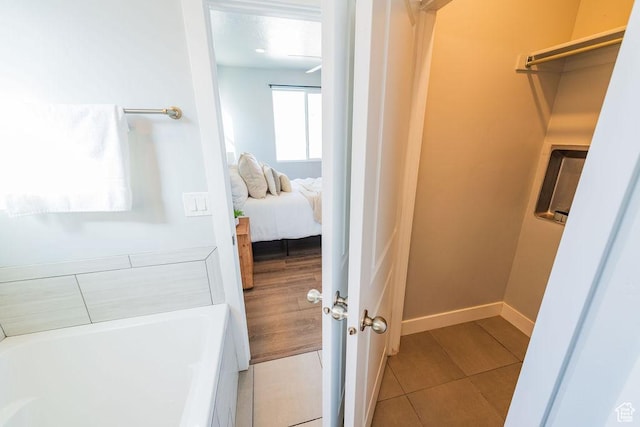 7390 N Pawnee Rd, Eagle Mountain, UT 84005 - ensuite bathroom with a tub to relax in and tile patterned floors