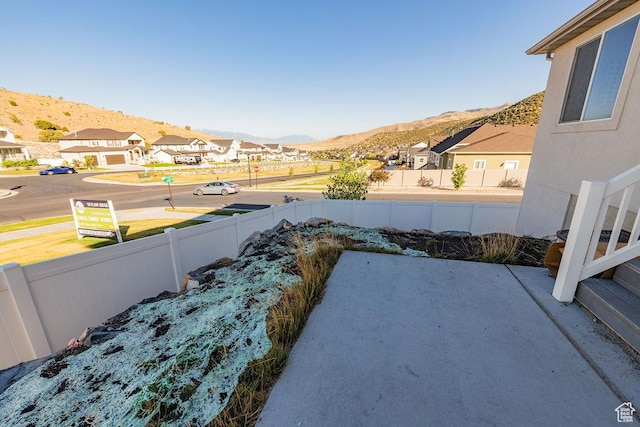 7390 N Pawnee Rd, Eagle Mountain, UT 84005 - view of yard with a mountain view, a patio area, and a residential view