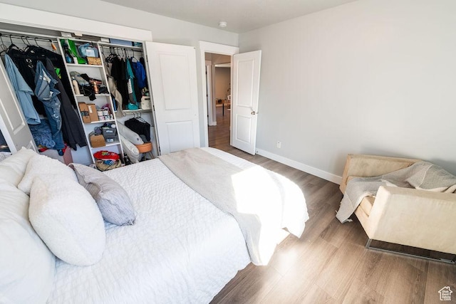7390 N Pawnee Rd, Eagle Mountain, UT 84005 - bedroom featuring wood finished floors and a closet