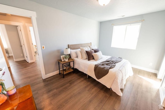 7390 N Pawnee Rd, Eagle Mountain, UT 84005 - bedroom featuring wood finished floors and baseboards