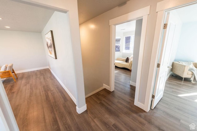 7390 N Pawnee Rd, Eagle Mountain, UT 84005 - hallway featuring dark wood-style floors and baseboards