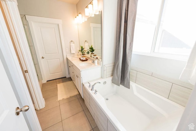 7390 N Pawnee Rd, Eagle Mountain, UT 84005 - bathroom with a relaxing tiled tub, vanity, and tile patterned floors