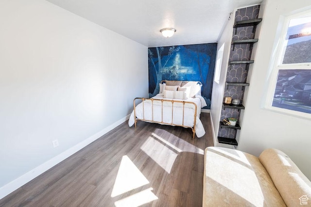7390 N Pawnee Rd, Eagle Mountain, UT 84005 - bedroom with wood finished floors, an accent wall, and multiple windows