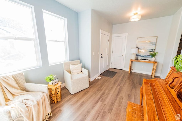 7390 N Pawnee Rd, Eagle Mountain, UT 84005 - living area featuring light wood-style floors and baseboards