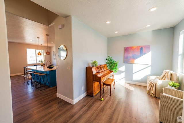 7390 N Pawnee Rd, Eagle Mountain, UT 84005 - sitting room featuring dark wood-type flooring, recessed lighting, and a textured ceiling