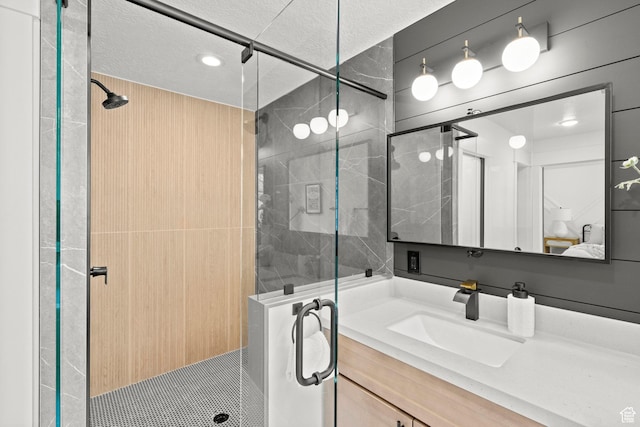 3873 E S Pass Cv, Eagle Mountain, UT 84005 - ensuite bathroom with a shower stall, vanity, and a textured ceiling