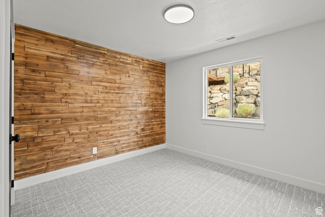 3873 E S Pass Cv, Eagle Mountain, UT 84005 - empty room with wood walls, carpet flooring, and a textured ceiling