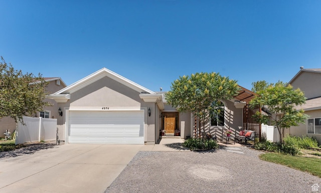 4974 W Diamondback Dr, Riverton, UT 84096 - view of front of home featuring concrete driveway, a garage, and stucco siding