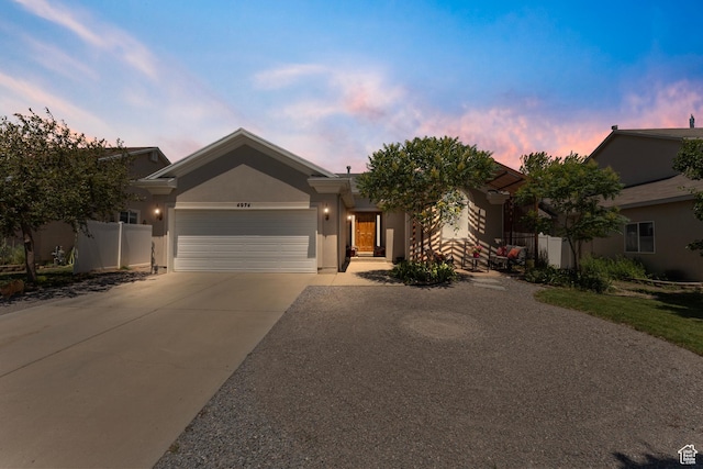 4974 W Diamondback Dr, Riverton, UT 84096 - view of front facade featuring an attached garage, driveway, and stucco siding