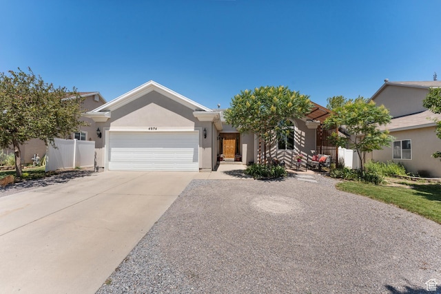4974 W Diamondback Dr, Riverton, UT 84096 - view of front of home with a garage, driveway, and stucco siding