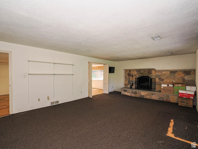 4893 S Regency St, Holladay, UT 84117 - unfurnished living room featuring a textured ceiling, a stone fireplace, and carpet floors