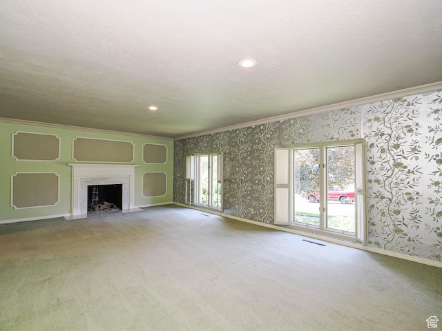 4893 S Regency St, Holladay, UT 84117 - unfurnished living room with crown molding, carpet floors, wallpapered walls, a fireplace with flush hearth, and recessed lighting
