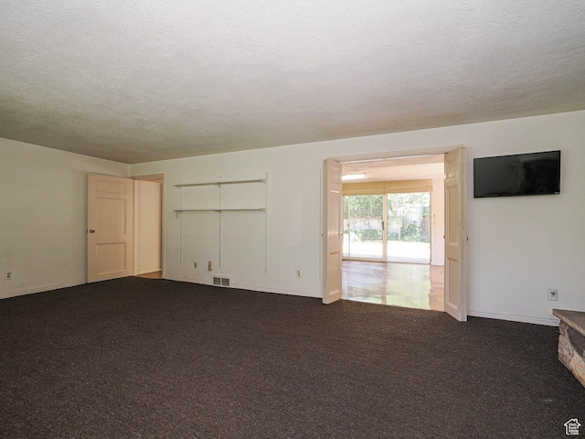 4893 S Regency St, Holladay, UT 84117 - unfurnished living room with a textured ceiling and dark carpet