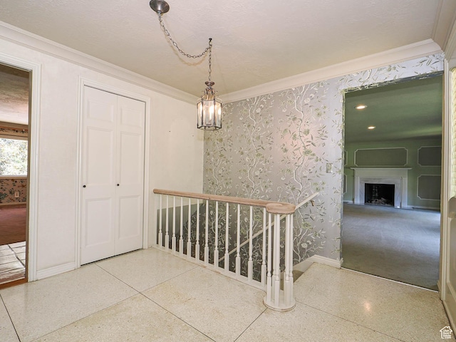 4893 S Regency St, Holladay, UT 84117 - corridor featuring speckle patterned floor, ornamental molding, and an upstairs landing