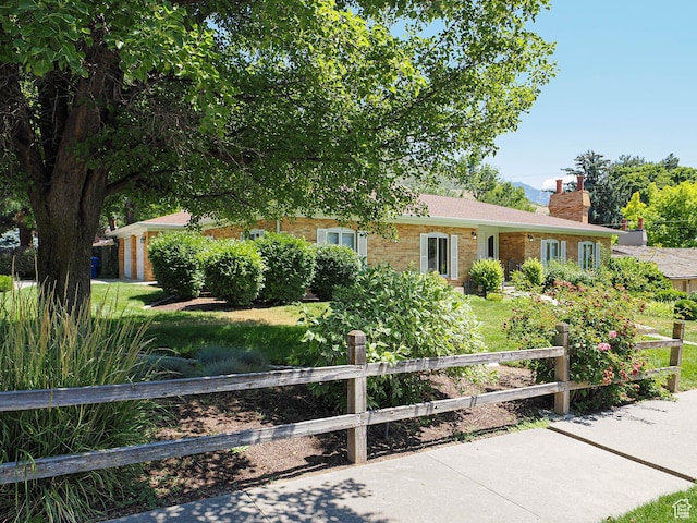 4893 S Regency St, Holladay, UT 84117 - ranch-style house with brick siding and a chimney