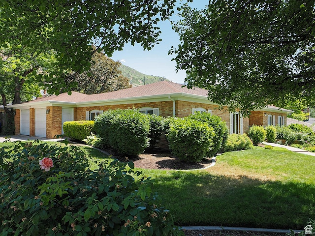 4893 S Regency St, Holladay, UT 84117 - view of front of home with a garage, brick siding, a front lawn, and concrete driveway
