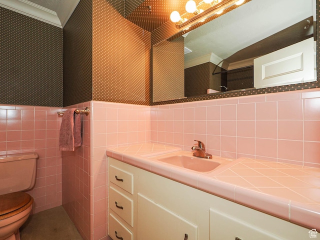 4893 S Regency St, Holladay, UT 84117 - bathroom featuring tile walls, vanity, wallpapered walls, crown molding, and a wainscoted wall