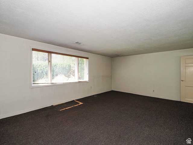4893 S Regency St, Holladay, UT 84117 - spare room featuring dark colored carpet and a textured ceiling