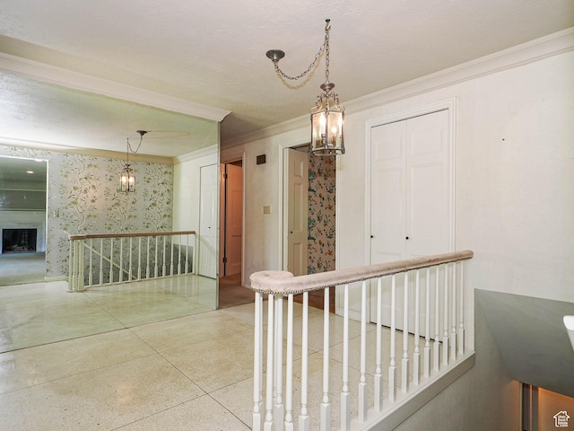 4893 S Regency St, Holladay, UT 84117 - hallway with a chandelier, an upstairs landing, ornamental molding, and speckled floor