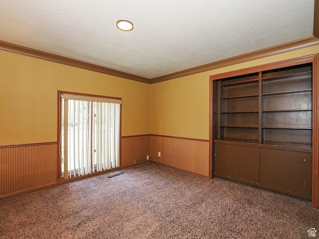 4893 S Regency St, Holladay, UT 84117 - carpeted empty room featuring a wainscoted wall, ornamental molding, and a textured ceiling