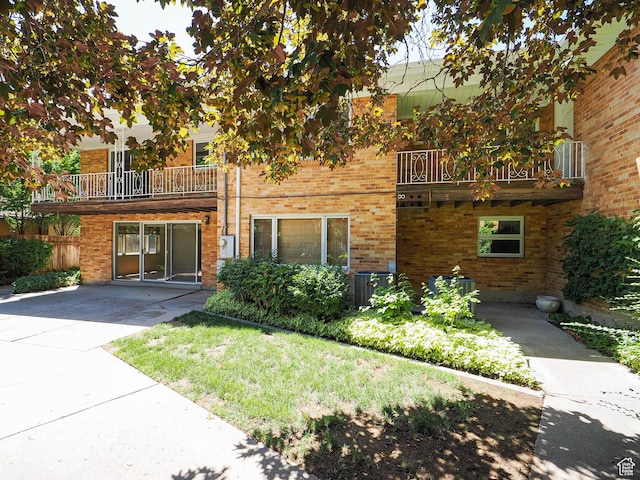 4893 S Regency St, Holladay, UT 84117 - view of front of property with a balcony and brick siding