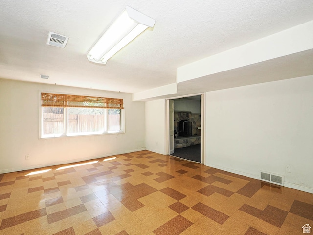 4893 S Regency St, Holladay, UT 84117 - spare room featuring light floors and a textured ceiling