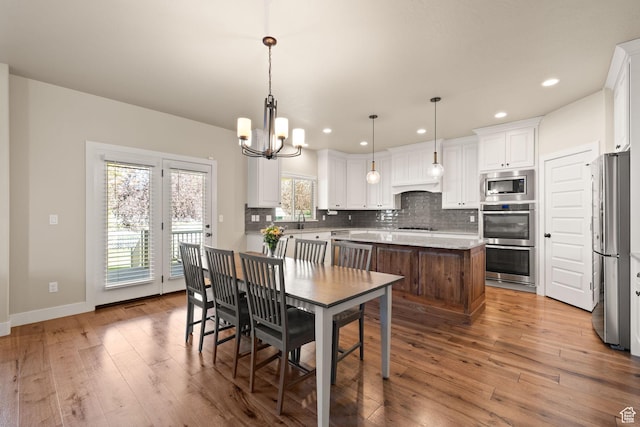 13571 S Meadow Heights Ln, Draper, UT 84020 - dining area with light wood-style flooring, a chandelier, and recessed lighting