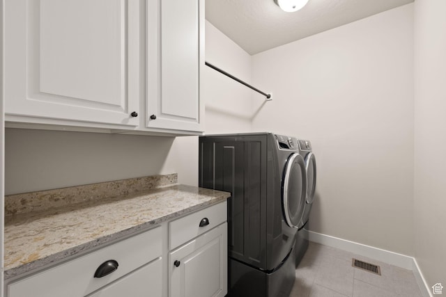 13571 S Meadow Heights Ln, Draper, UT 84020 - laundry room with washer and clothes dryer, cabinet space, and tile patterned floors