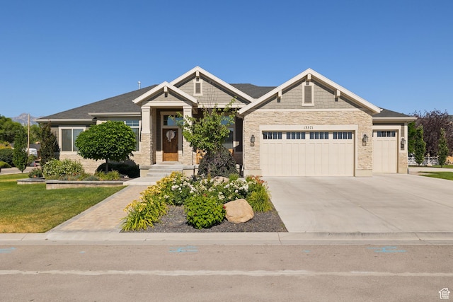 13571 S Meadow Heights Ln, Draper, UT 84020 - craftsman-style house with a garage, driveway, stone siding, and a front yard