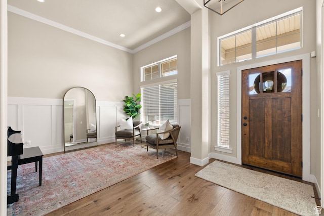 13571 S Meadow Heights Ln, Draper, UT 84020 - entrance foyer with a high ceiling, ornamental molding, plenty of natural light, hardwood / wood-style flooring, and a wainscoted wall