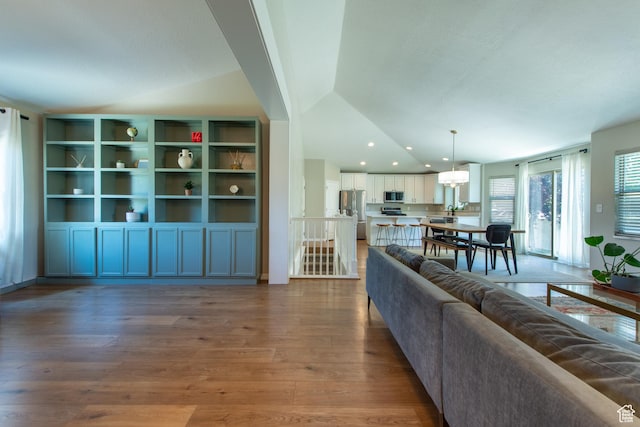 552 E Sunset Stream Way, Draper, UT 84020 - living room featuring lofted ceiling, wood finished floors, and a chandelier