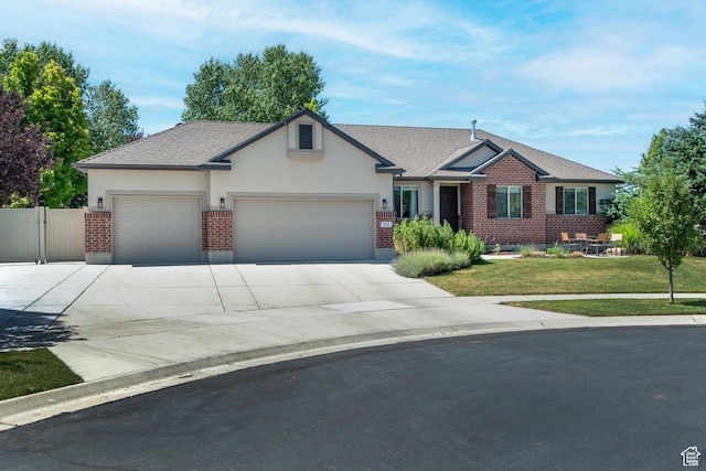 552 E Sunset Stream Way, Draper, UT 84020 - view of front of property with a garage, brick siding, concrete driveway, and roof with shingles