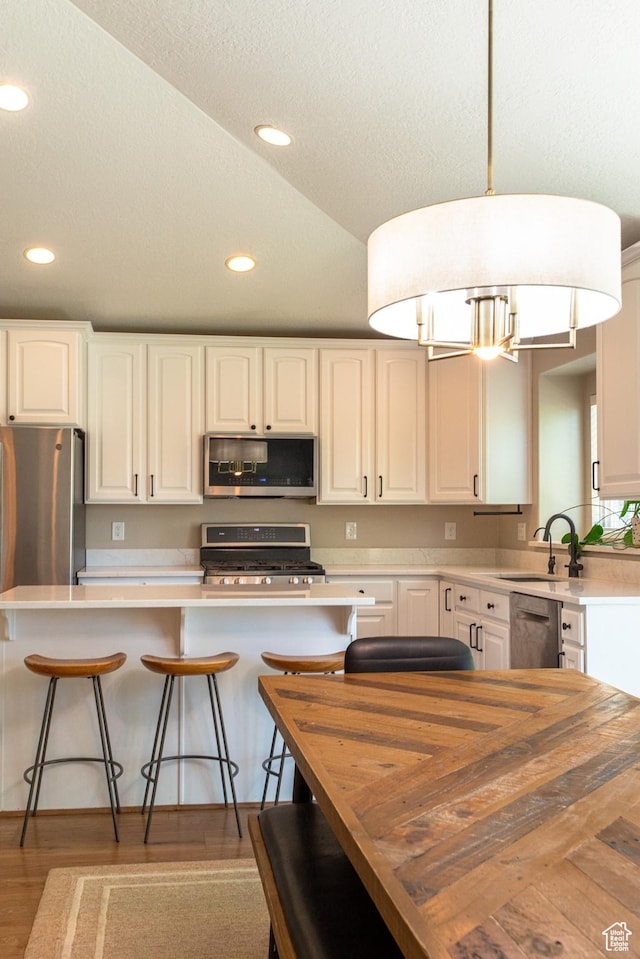 552 E Sunset Stream Way, Draper, UT 84020 - kitchen featuring appliances with stainless steel finishes, butcher block counters, recessed lighting, white cabinets, and a breakfast bar