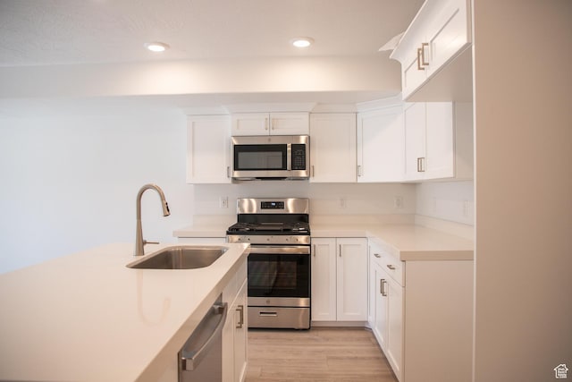1362 N 1810 E, Spanish Fork, UT 84660 - kitchen with stainless steel appliances, light countertops, light wood-type flooring, white cabinetry, and recessed lighting