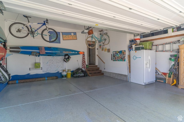 10296 S Salmon Dr, South Jordan, UT 84095 - garage with white refrigerator with ice dispenser and a garage door opener
