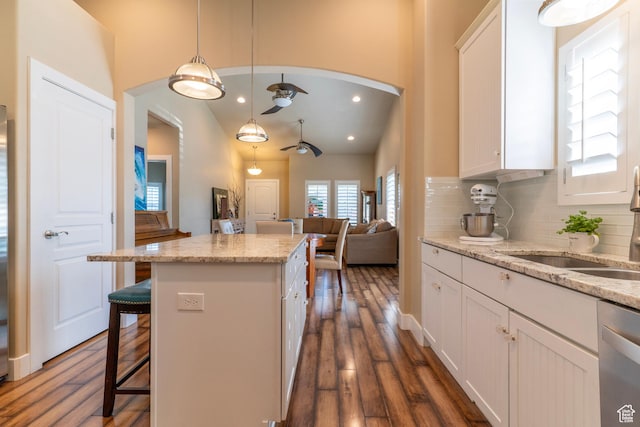 10296 S Salmon Dr, South Jordan, UT 84095 - kitchen featuring ceiling fan, dishwasher, a kitchen island, white cabinetry, and backsplash