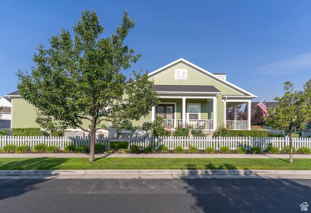 10296 S Salmon Dr, South Jordan, UT 84095 - view of front facade featuring a porch and a fenced front yard