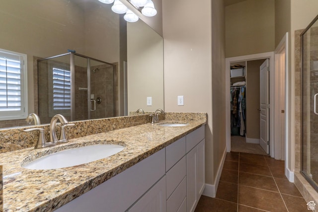 10296 S Salmon Dr, South Jordan, UT 84095 - bathroom with a stall shower, double vanity, tile patterned floors, and a walk in closet