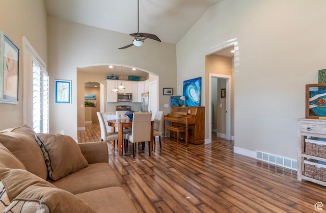 10296 S Salmon Dr, South Jordan, UT 84095 - living area featuring arched walkways, high vaulted ceiling, a ceiling fan, and dark wood finished floors