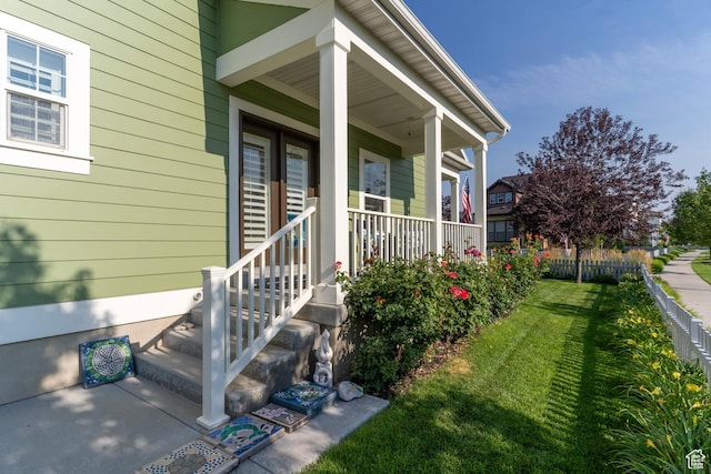 10296 S Salmon Dr, South Jordan, UT 84095 - view of exterior entry featuring a yard and covered porch