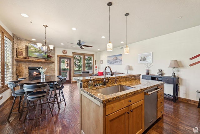 9855 Vista Dr Unit 103, Heber City, UT 84032 - kitchen featuring ceiling fan, stainless steel dishwasher, dark wood-style floors, open floor plan, and an island with sink